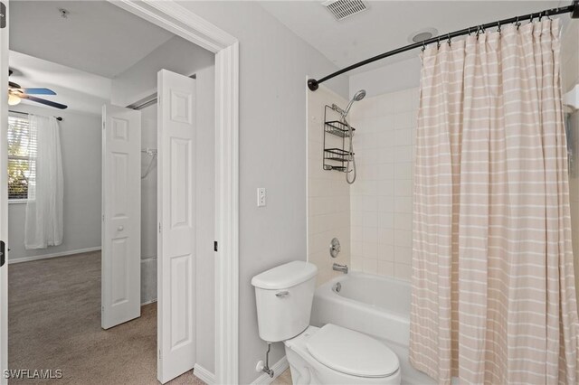 bathroom with shower / bathtub combination with curtain, ceiling fan, and toilet