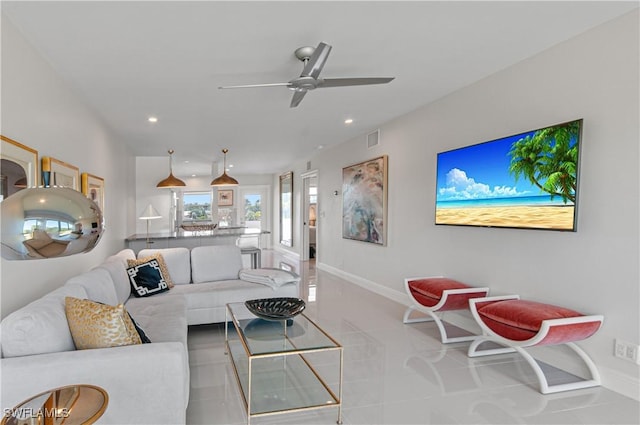 tiled living room with ceiling fan