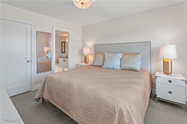 bedroom featuring light colored carpet and ensuite bath