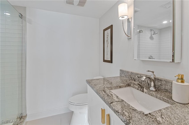 bathroom with vanity, toilet, and an enclosed shower