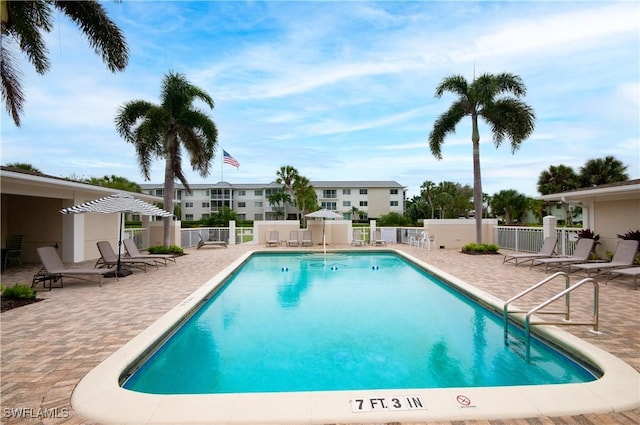 view of swimming pool featuring a patio area and a pergola