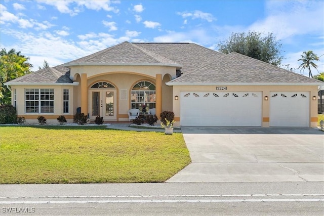 view of front of house with a garage and a front lawn