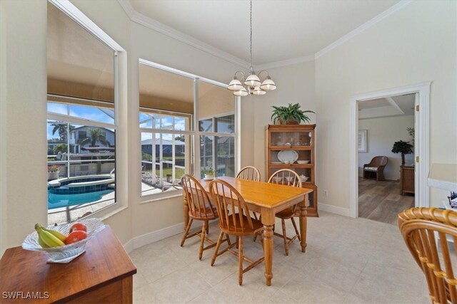 dining space featuring ornamental molding and a chandelier