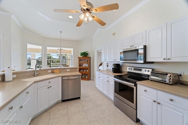 kitchen with white cabinetry, hanging light fixtures, and stainless steel appliances