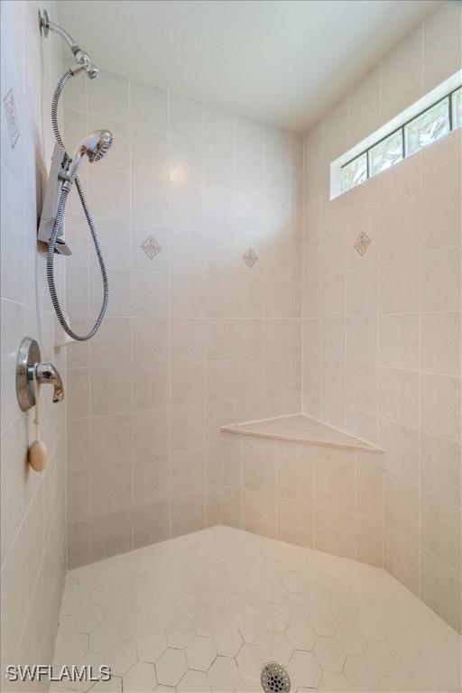 bathroom with a tile shower