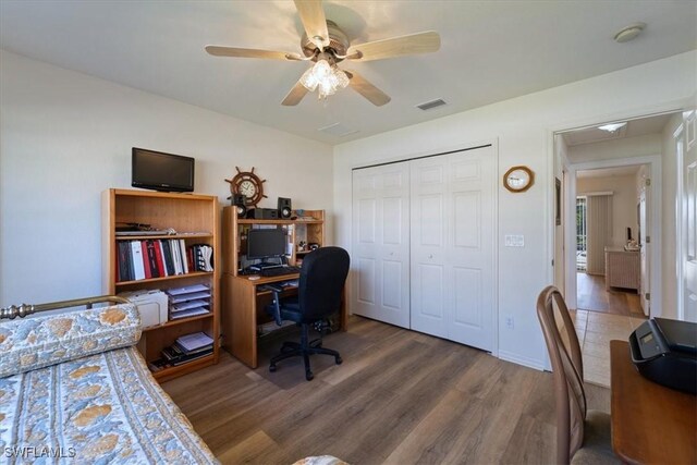 home office with ceiling fan and hardwood / wood-style floors