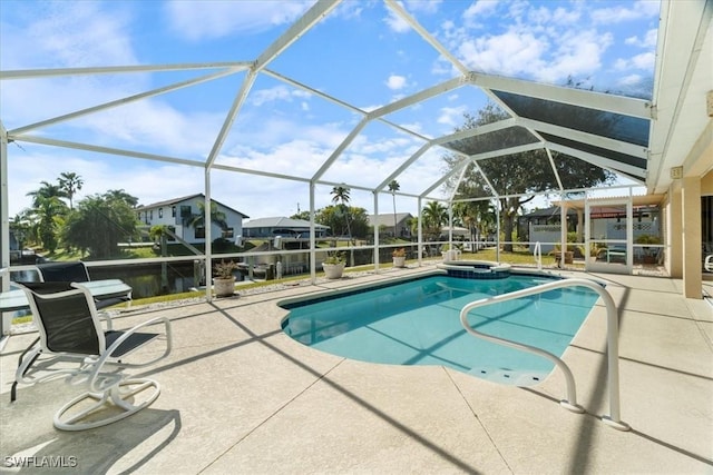 view of swimming pool with a lanai, a patio area, and an in ground hot tub