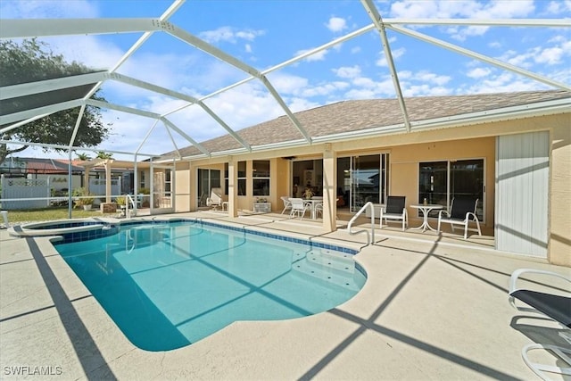 view of swimming pool with an in ground hot tub, a lanai, and a patio area