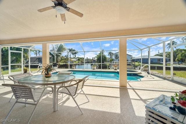 view of pool featuring an in ground hot tub, a lanai, and a patio