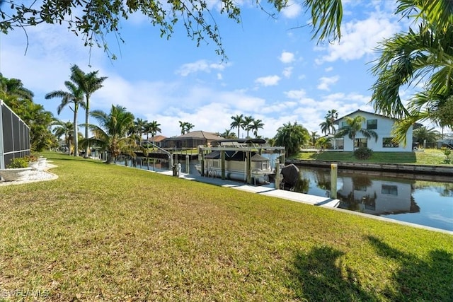 dock area featuring a lawn and a water view