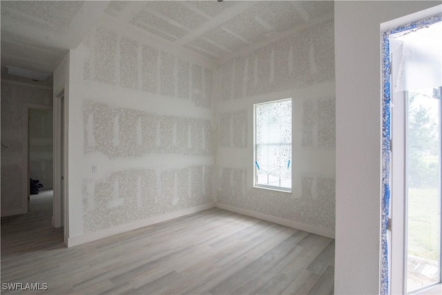 empty room featuring wood finished floors and baseboards