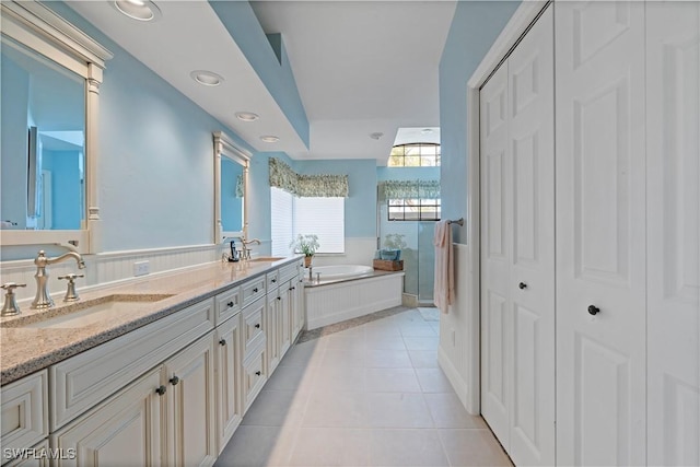 bathroom featuring vanity, tile patterned floors, and a bathing tub