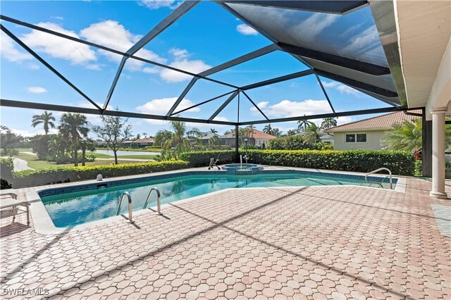 view of swimming pool with a patio, an in ground hot tub, and glass enclosure