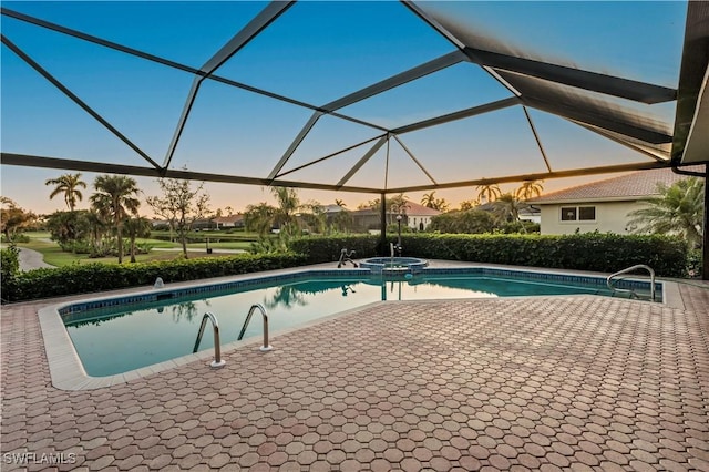 pool at dusk with a lanai