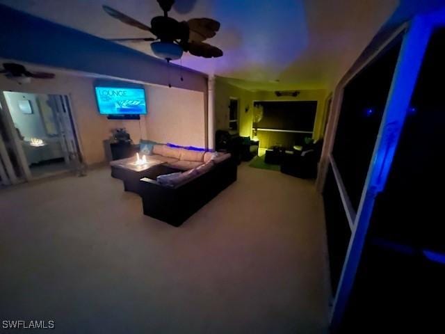 cinema room with carpet floors and ceiling fan