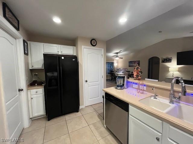 822 Johns Ave, Lehigh Acres, FL 33972 - kitchen featuring black fridge with ice dispenser, dishwasher, arched walkways, vaulted ceiling, and white cabinetry