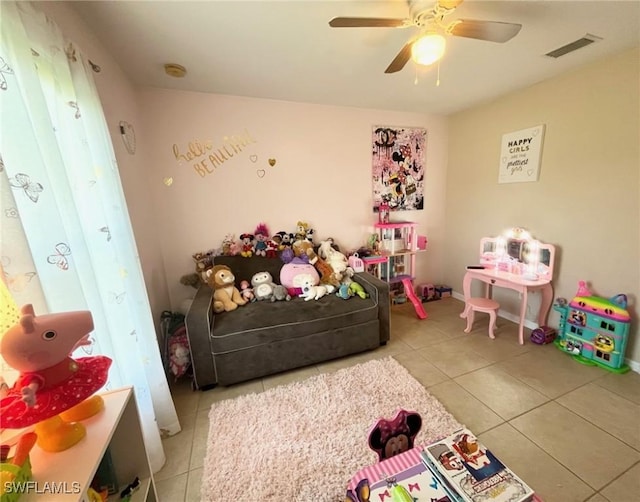 interior space with tile patterned floors and ceiling fan