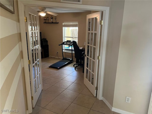 workout room with light tile patterned floors, french doors, and ceiling fan