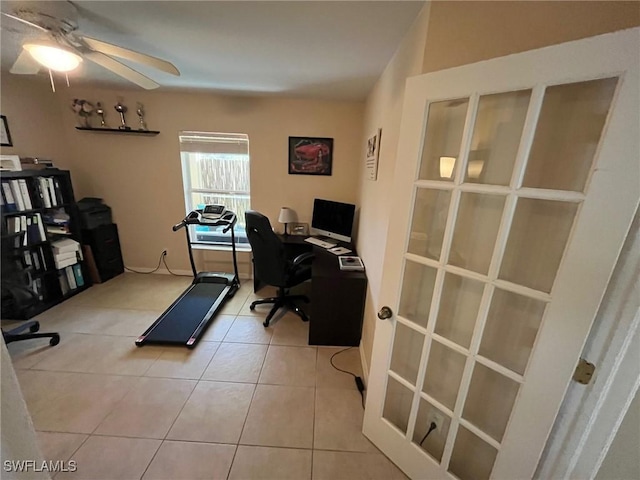 tiled home office featuring ceiling fan