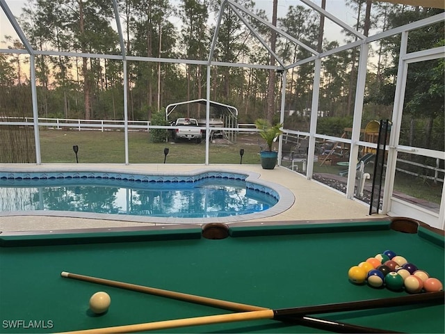 pool with a yard, a patio area, and a lanai