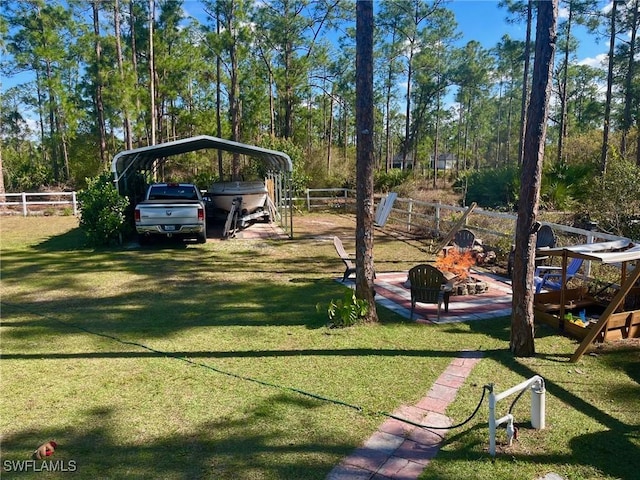 view of home's community with a carport, a yard, and fence