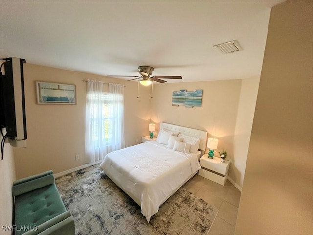 tiled bedroom featuring visible vents, baseboards, and ceiling fan