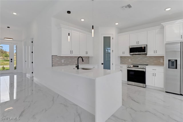 kitchen with white cabinetry, pendant lighting, stainless steel appliances, and sink