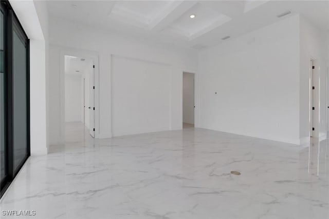 unfurnished room with coffered ceiling, beamed ceiling, and a towering ceiling