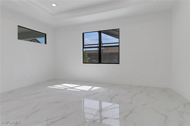 empty room featuring a tray ceiling