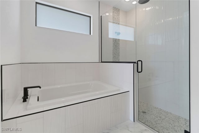 bathroom with separate shower and tub