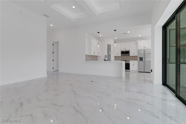 unfurnished living room featuring sink and beam ceiling