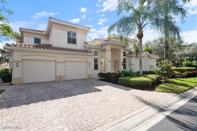 mediterranean / spanish-style house with a garage