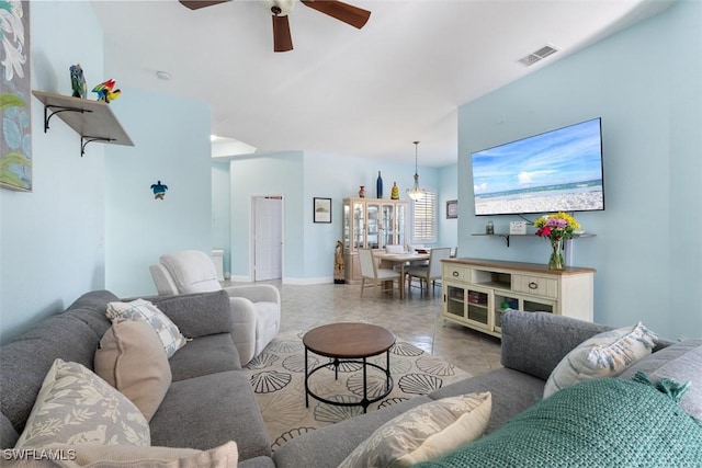 living room with ceiling fan and light tile patterned floors