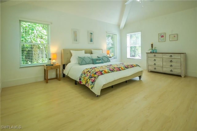 bedroom with multiple windows, ceiling fan, vaulted ceiling with beams, and light hardwood / wood-style floors