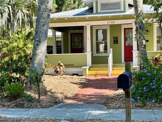 view of exterior entry featuring covered porch