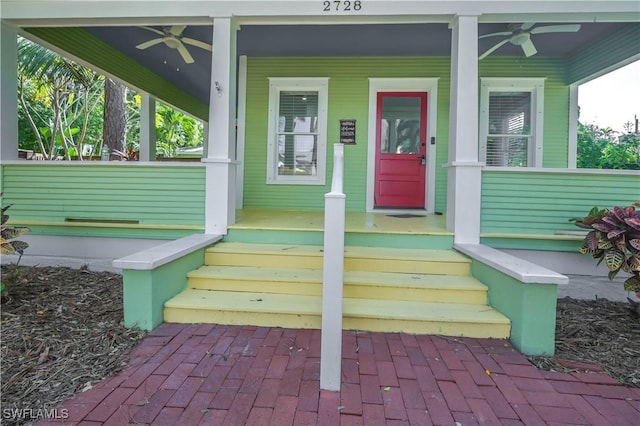 entrance to property featuring ceiling fan and a porch