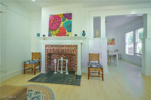 interior space featuring hardwood / wood-style flooring and a brick fireplace