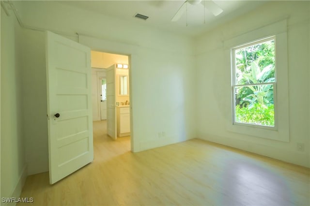 spare room with light hardwood / wood-style floors and ceiling fan