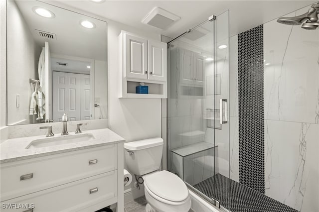 bathroom featuring vanity, an enclosed shower, and toilet