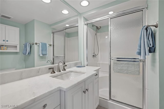 bathroom with an enclosed shower and vanity