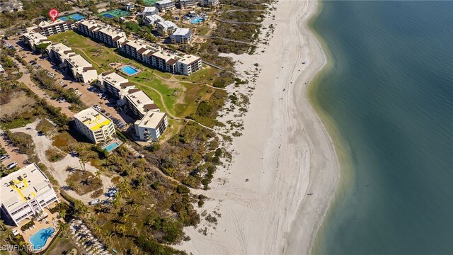 drone / aerial view featuring a view of the beach and a water view