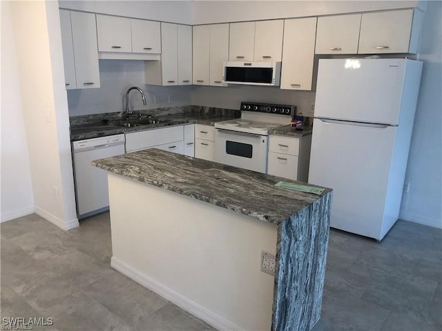 kitchen featuring sink, white cabinets, and white appliances