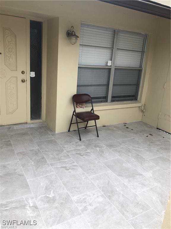 entrance to property featuring a patio