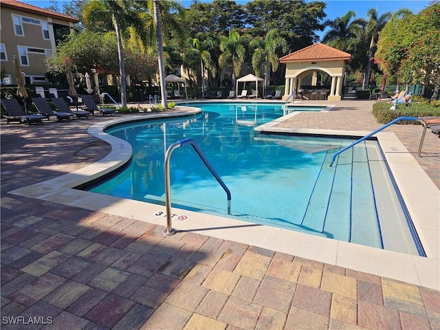 view of swimming pool with a gazebo and a patio area