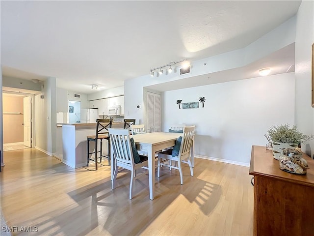 dining area with light hardwood / wood-style floors