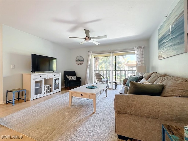 living room featuring ceiling fan and light wood-type flooring