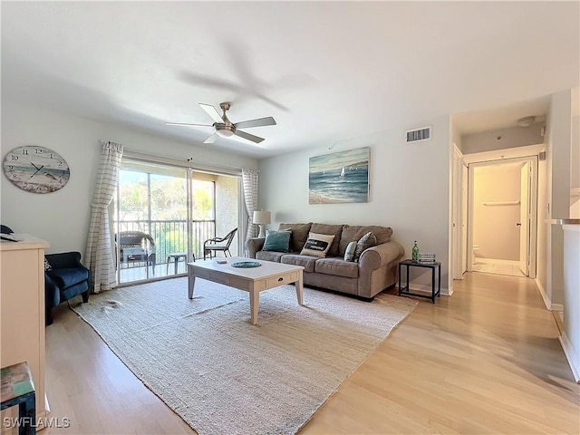 living room featuring light hardwood / wood-style flooring and ceiling fan