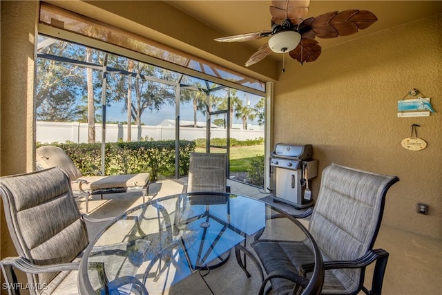 sunroom featuring ceiling fan