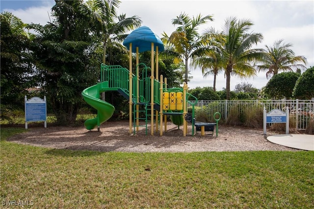 view of jungle gym featuring a lawn