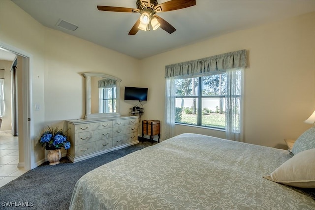 bedroom with vaulted ceiling, ceiling fan, and carpet